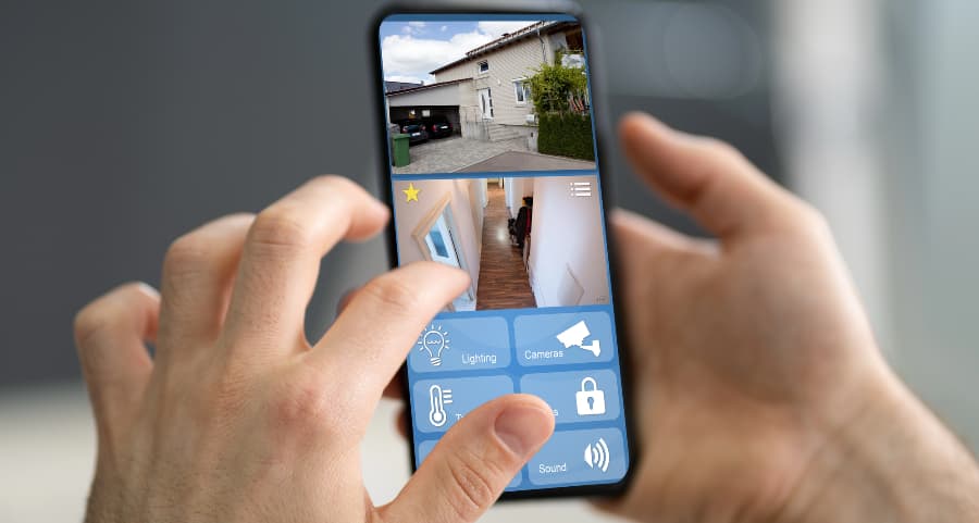 Homeowner looking at surveillance camera feeds on a mobile device